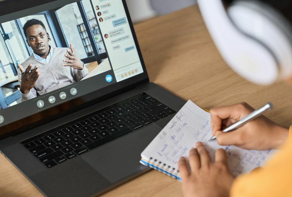 A student taking notes on a video call