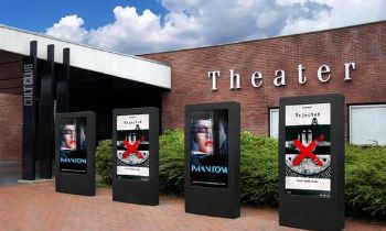 4 digital displays in front of a theatre