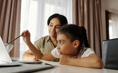Mother Helping her Daughter with Homework