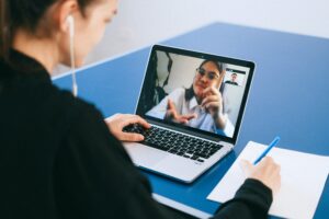 woman with headphones on a video conference