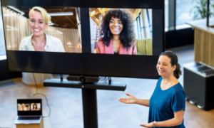 3 people using video conference system on a hybrid meeting